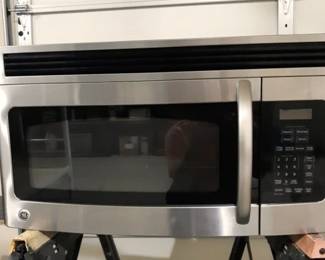 Over the stove GE vented microwave in stainless. A second over the stove microwave is available in white. Good working condition.