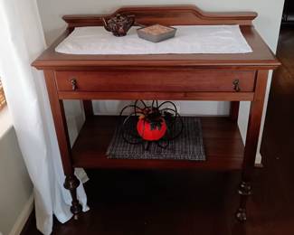 Antique Wood side serving table, with drawer, on wheels.