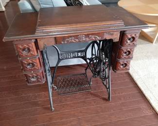 Antique Singer Sewing machine and cabinet.
