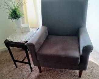 A compact, comfortable upholstered chair in charcoal gray. Like new .
Several side tables in different styles.
