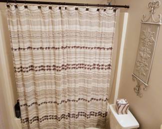 Stylish shower curtains and bathroom accessories are available from multiple bathrooms in the home.