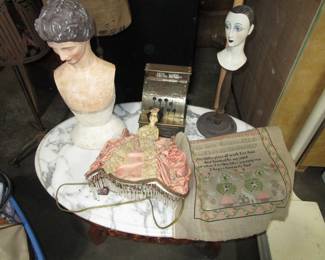 Antique marble table, boudoir lamp, small dress form busts, antique toy cash register, antique sampler