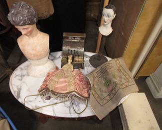 Antique marble table, boudoir lamp, small dress form busts, antique toy cash register, antique sampler
