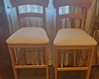 Several sets of tall barstool chairs