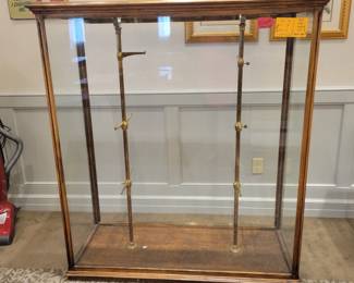 Tall brass and wood display cabinet