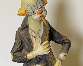 Hobo clown playing saxophone figurine