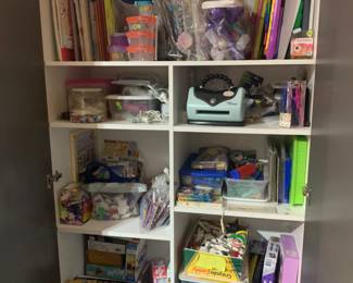 This cabinet is full of craft supplies, paints, kits,