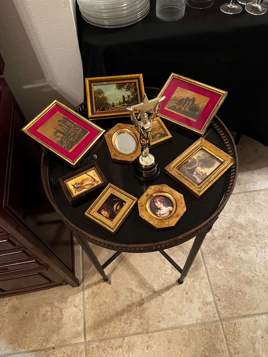 Marble topped table with small framed art
