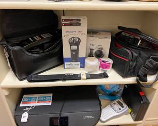 HP printer, old Southwestern Bell car phone, JVC camcorder, label makers, voice recorders
