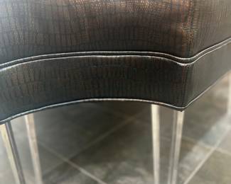 Up close of leather and acrylic ottoman