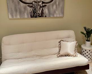Futon, bull art, rug