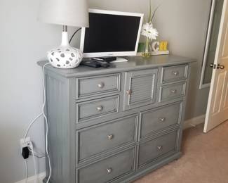 Large gray chest of drawers by young America; table lamp; TV