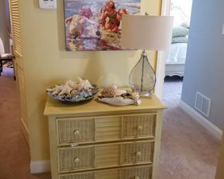 Yellow 3-drawer chest; beachy art; table lamp; seashell décor