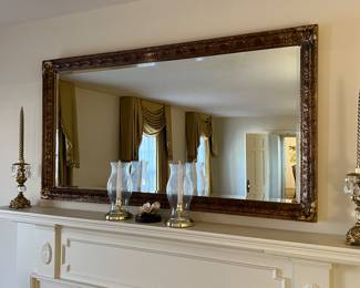 Gold framed wall mirror with brass candlesticks