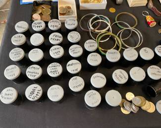COINS FROM AROUND THE WORLD.  SOLD PER OLD FILM CONTAINER.   