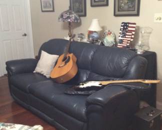nice reclining green sofa, acoustic guitar, electric guitar
