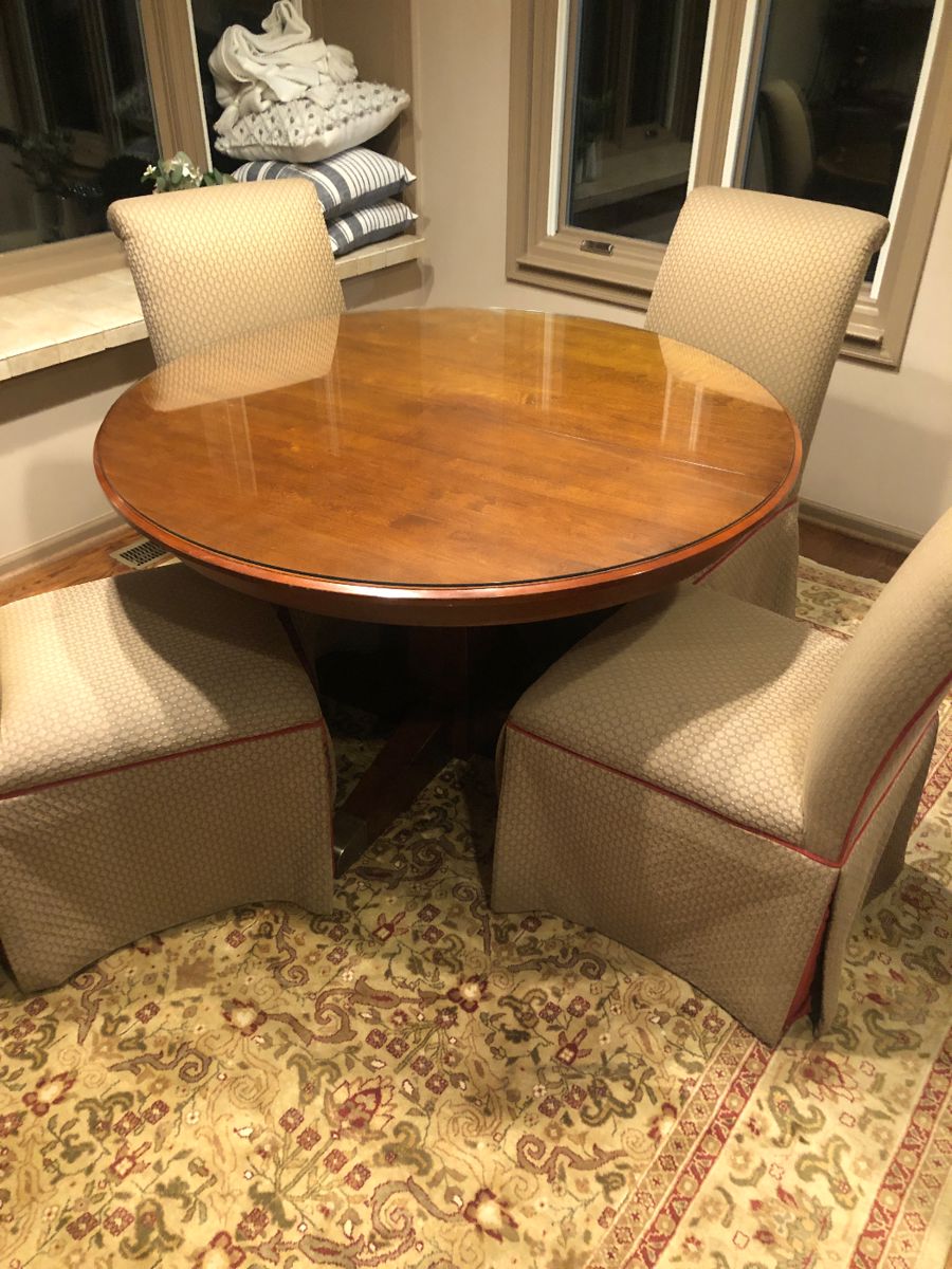 Ethan Allen pedestal table - one leaf - glass top (w/out leaf) - showing 4 skirted armless chairs w/ wood legs on casters -  Rug 