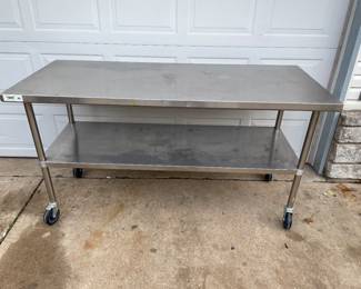$75  Regency Rolling Stainless Steel Work Table. It is made for commercial kitchens, but can be used for anything. 
72”’long
30”’deep
38 1/2” tall