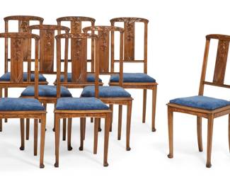 A set of eight French Art Nouveau walnut Mistletoe dining chairs
early 20th century