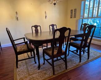 Late 19th Century Mahogany Queen Anne Dining Table with 6 chairs (1 arm chair), leaf extension and protective cover.  The area rug is also available and in very good condition.