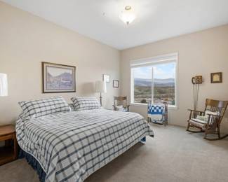 King Mattress and Box Springs. Two Antique Mission Rockers. Wood Side Tables. Two Brass Lamps. Handmade Quilts. Quilt Hanger. 