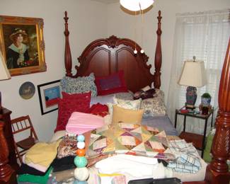 Tall mahogany Queen poster bed with quilts and bed linens 