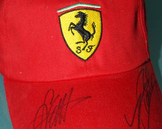 Signed Ferrari hat-unknown signatures. The thought is that these signatures are from 2014 Formula One race car drivers