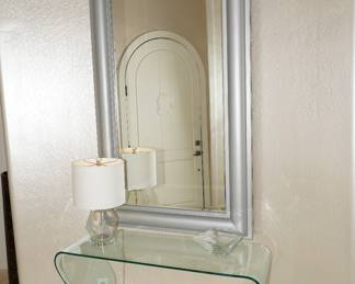 Waterfall glass hall table with gray framed wall mirror