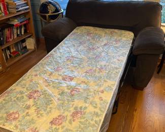 Family Room-Main Floor: The over-size chair-sleeper is now open to reveal a twin bed. This piece is in great condition and still has its original tags and plastic on the mattress.