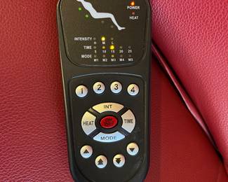 Family Room-Main Floor: This is the remote to the red "Powered Zero Gravity Chair" that works great! Its footrest raises; the seat raises; and it reclines.