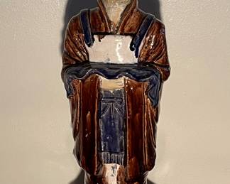 Living Room: A colorful glazed clay figure of a Chinese attendant is 32" tall.