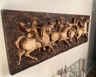 Living Room:  This fiberglass mid-century 1960's Brutalist wall sculpture depicts four horses and warriors.  It is 3-D as shown and measures 62" wide x 5" thick x 21" tall.