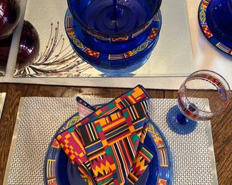 Dining Room: This is one of the place settings shown with one of a set of six place mats, colorful napkins, and acrylic "C" monogrammed napkins holders. The colorful pattern is called KENTE.