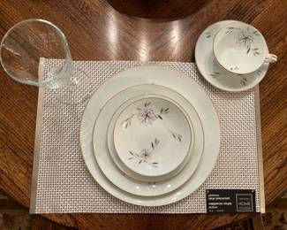 Dining Room: This is one place setting of the previously shown vintage NORITAKE china in the "Helene" pattern. The entire set includes: 13 dinner plates (four are in the china cabinet); 8 salad plates; 7 dessert plates; 7 saucers; 6 coffee cups; one 16" oval platter; one 14" oval platter; one round serving bowl; four oval serving bowls; gravy with attached under-plate; one creamer; and one sugar, for a total of 51 pieces. The set of six woven silver place mats is also for sale.