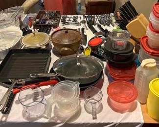 Measuring cups, plastic storage, tupperware, trivets, knives, casserole dishes, pottery