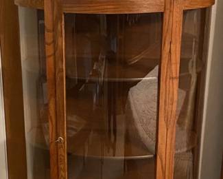 ANTIQUE BOWFRONT HANDBLOWN GLASS CURIO CABINET.