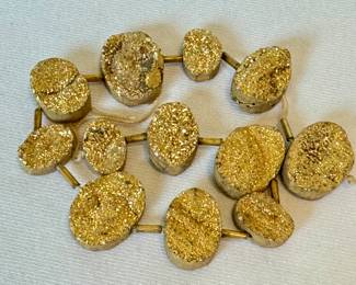 (12) Druzy Gold Oval Agate Beads with the strand measuring nine inches long. 