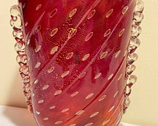 Hand Blown Art Glass Ruby Red Vase with Applied Ribbon Detailing and accented with beautiful gold colored flecks. 

Measures 10"h x 6.25" wide