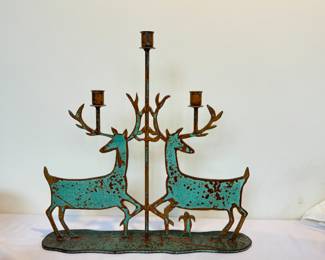 Metal Artisan Deer Figurine Double Candle Holder with great patina which provides a wonderful rustic look!

Measures 17.5" x 17.5" 