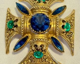 Vintage Fiorenza Maltese Cross Brooch with green cabochons and blue rhinestones, measuring 2.5 inches.