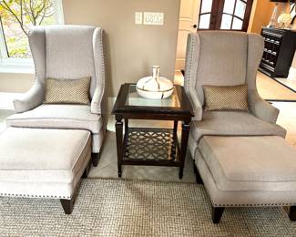 pair of matching chairs with ottomans