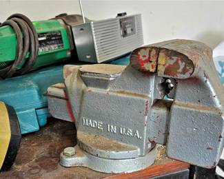 Bench vise and lots of hand tools. plumbing fittings, electrical. All things used by a handyman.