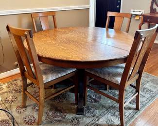 Round oak dining table with one leaf and 6 chairs