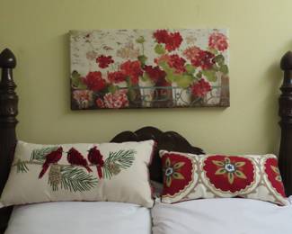 Lots of throw pillows and floral wrapped art.