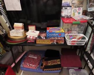 New boxed games, Christmas chargers,. Containers of Christmas ribbons. Packs of fabrics.