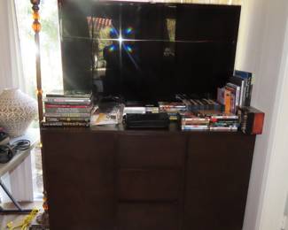 Samsung TV, Tv/media stand, DVDs and books.