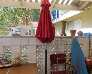 Red and blue patio umbrellas with stands.