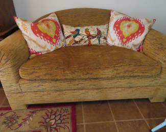 One of two tiger print love seats and fun throw pillows.
