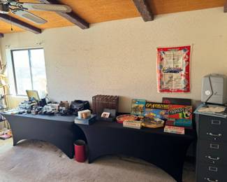 Cameras and electronics in office area, tons of board games and vintage puzzles