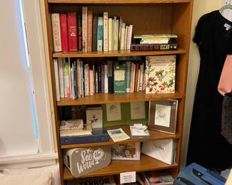 7 shelf tower bookcase, frames, photo albums, books, luggage and pillows.